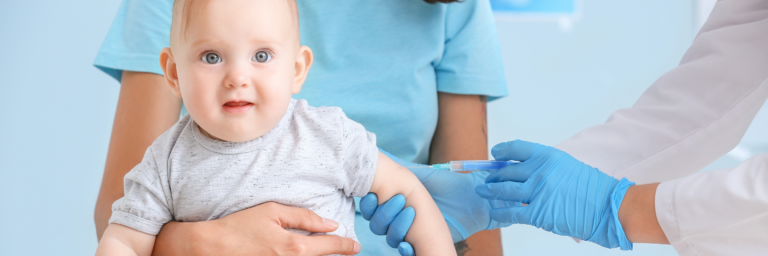 a baby being vaccinated by a nurse